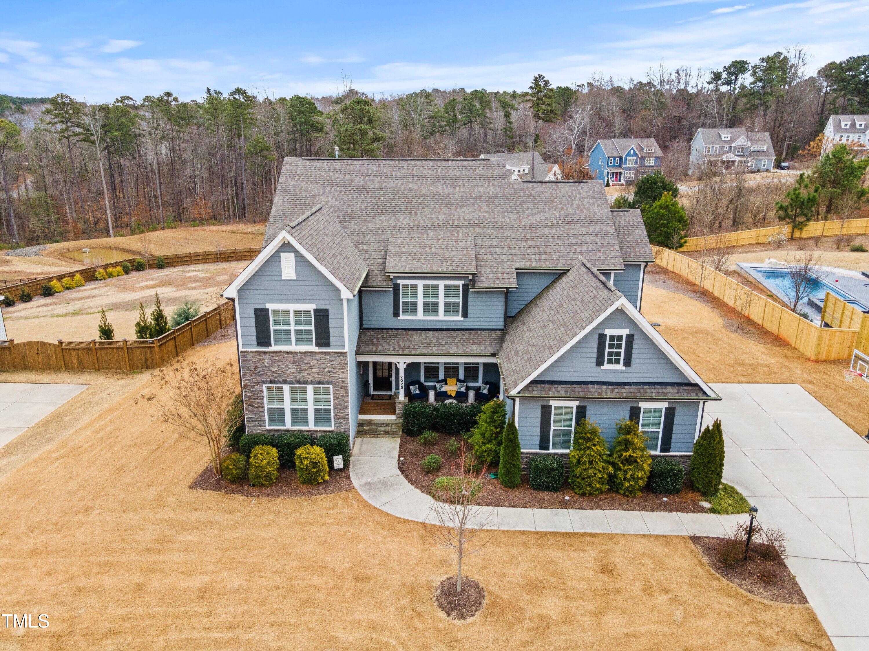 2025 Braeburn Drive Apex, NC 27539 - Photo 63 of 71 a front view of a house with a yard