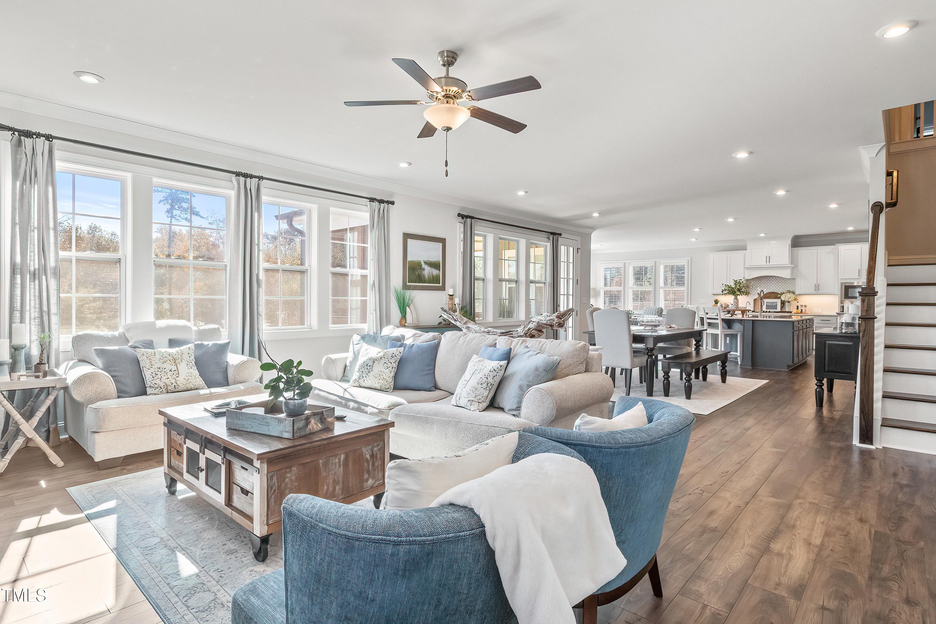 2025 Braeburn Drive Apex, NC 27539 - Photo 7 of 71 a living room with furniture kitchen view and a large window