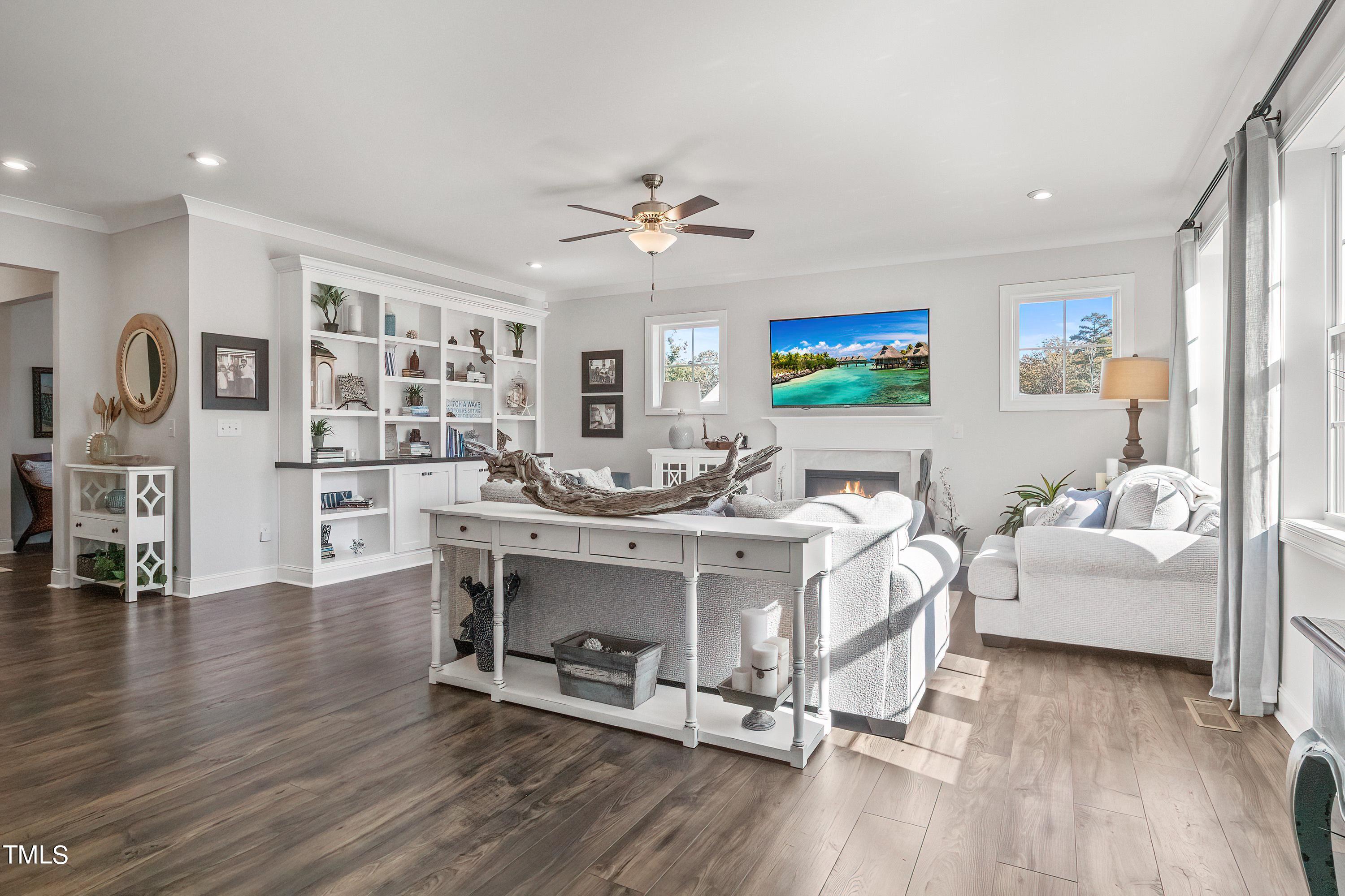 2025 Braeburn Drive Apex, NC 27539 - Photo 9 of 71 a living room with fireplace furniture and a wooden floor