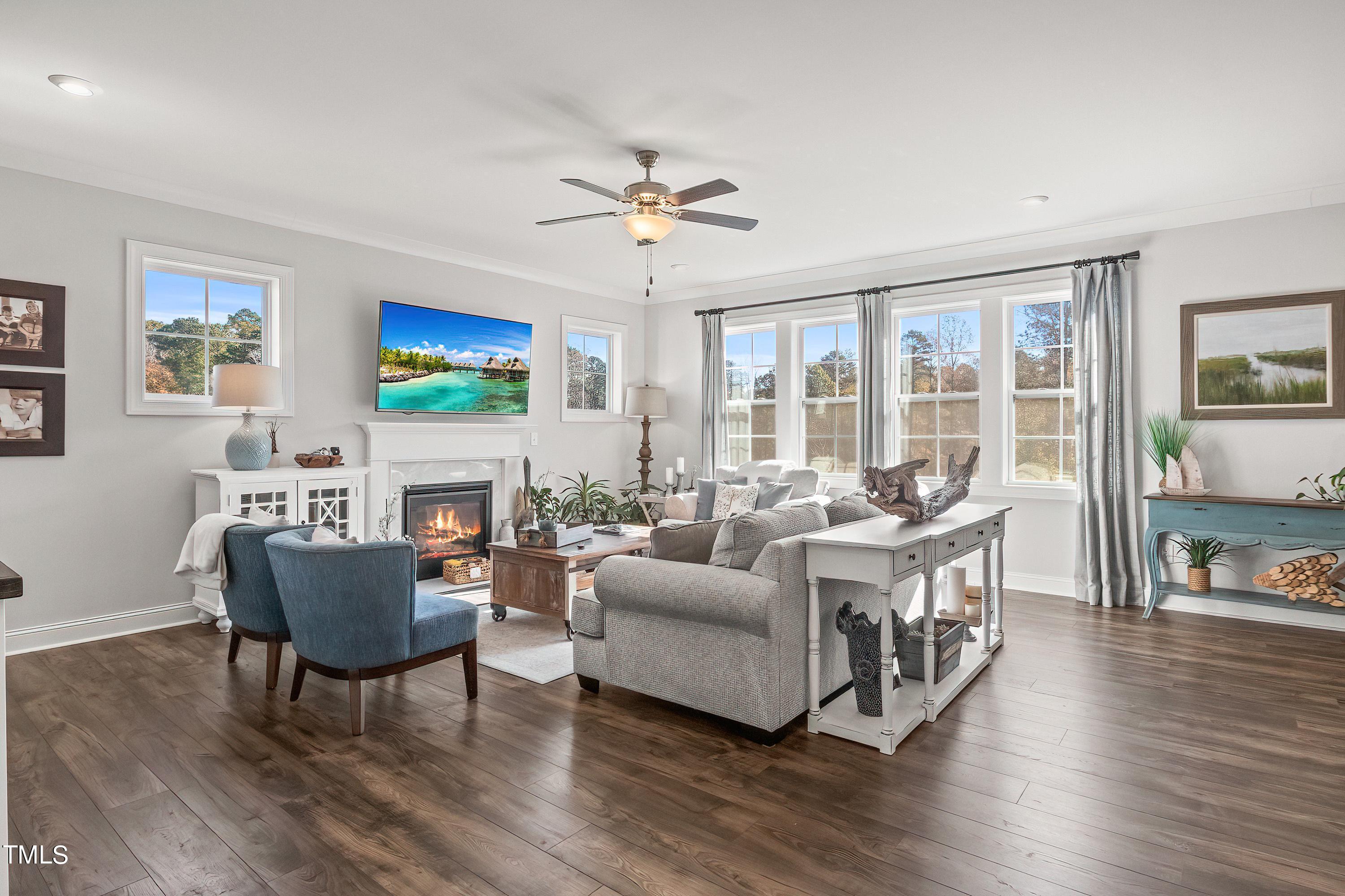 2025 Braeburn Drive Apex, NC 27539 - Photo 10 of 71 a living room with fireplace furniture and a flat screen tv