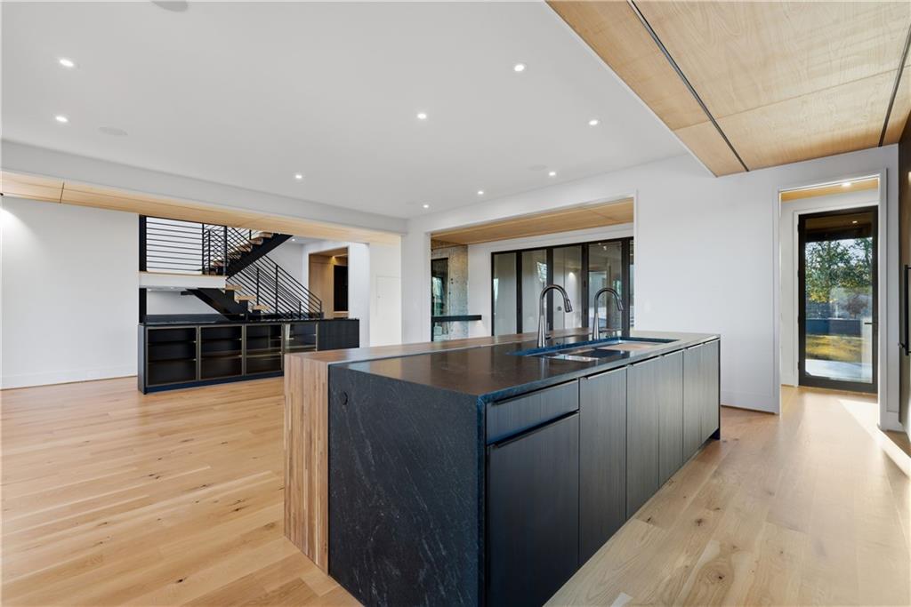 1033 Reeder Circle Northeast Atlanta, GA 30306 - Photo 19 of 52 a kitchen with stainless steel appliances granite countertop a sink counter space and wooden floor