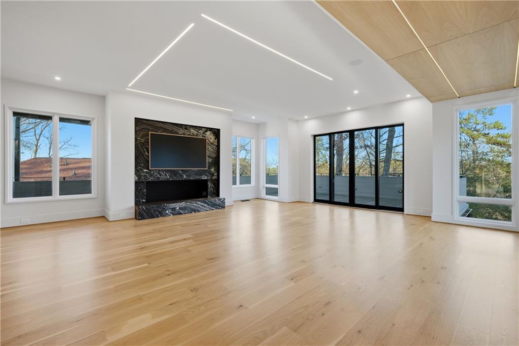 1033 Reeder Circle Northeast Atlanta, GA 30306 - Photo 22 of 52 a view of an empty room with wooden floor and a fireplace