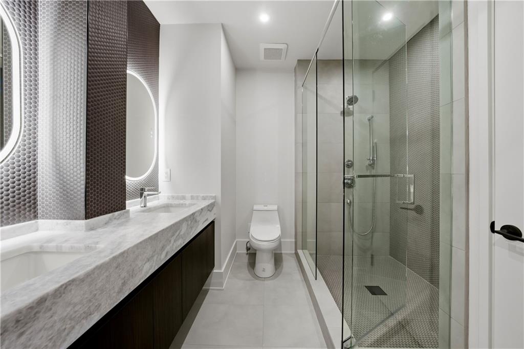 1033 Reeder Circle Northeast Atlanta, GA 30306 - Photo 9 of 52 a bathroom with a granite countertop sink a toilet and shower