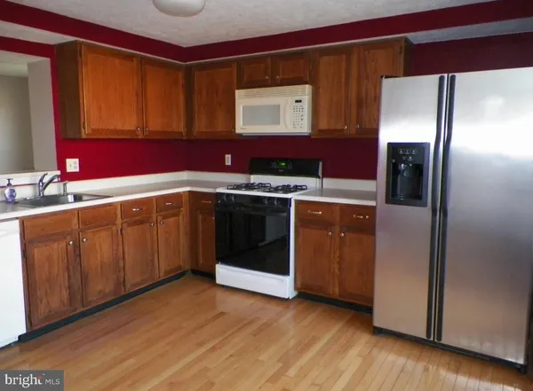 a kitchen with a sink stove and refrigerator