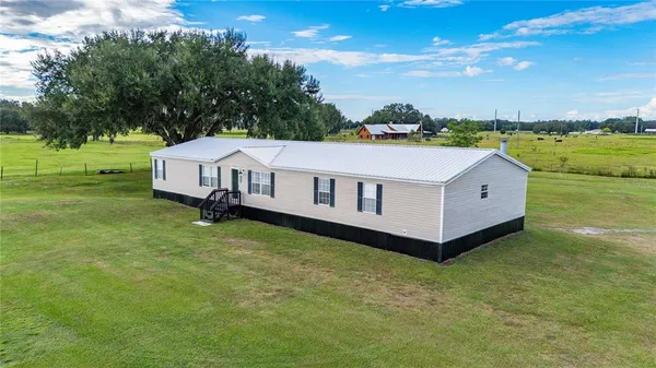 a view of a house with a big yard