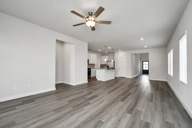 a kitchen with a white stove top oven and refrigerator