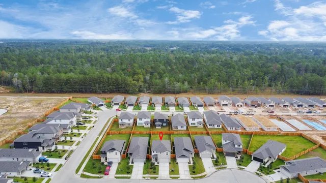an aerial view of residential houses with outdoor space