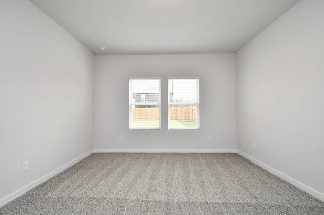 a view of an empty room and closet area