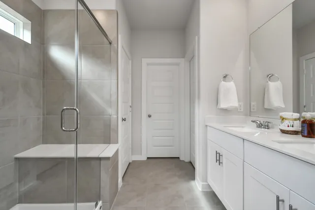 a bathroom with a double vanity sink and mirror