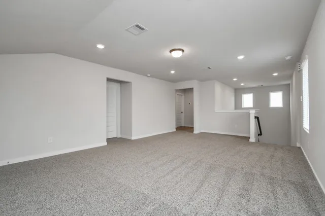 an empty room with a empty space and windows