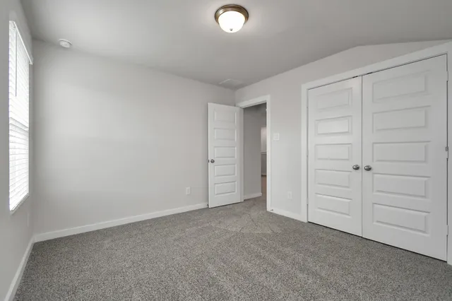 a bathroom with a granite countertop sink a toilet and a mirror