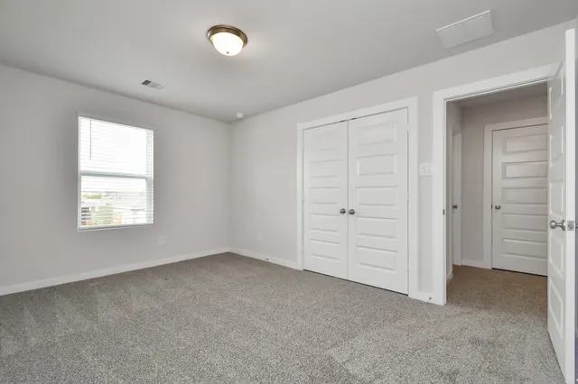 an empty room with closet area