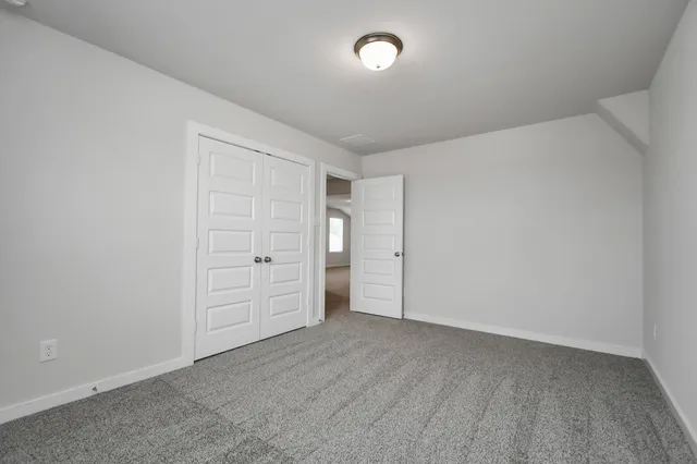 an empty room with closet area