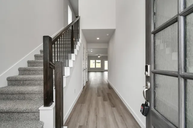 a view of kitchen with granite countertop stainless steel appliances refrigerator sink and cabinets