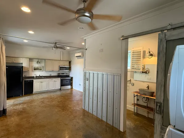 a large kitchen with cabinets and stainless steel appliances