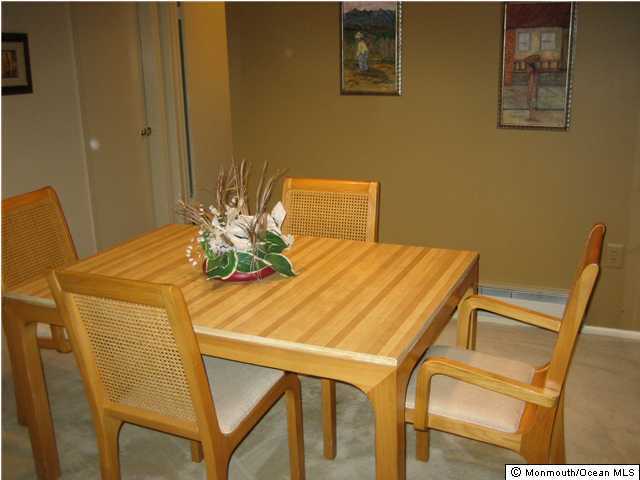 98 Arrowood Road, Unit C Manalapan, NJ 07726 - Photo 3 of 3 a dining room with chairs and wooden floor