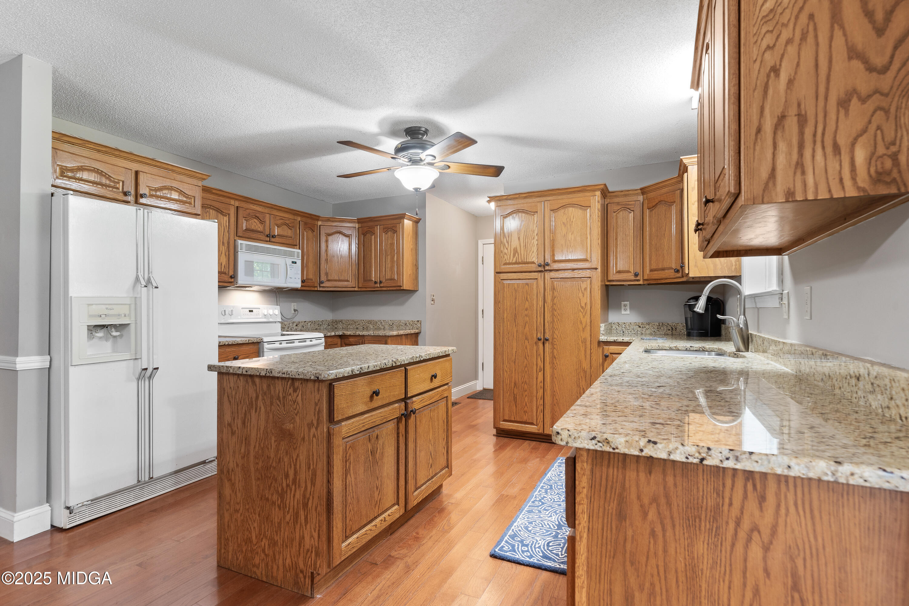 299 Colvin Road Forsyth, GA 31029 - Photo 11 of 51 a kitchen with stainless steel appliances granite countertop a sink stove and refrigerator