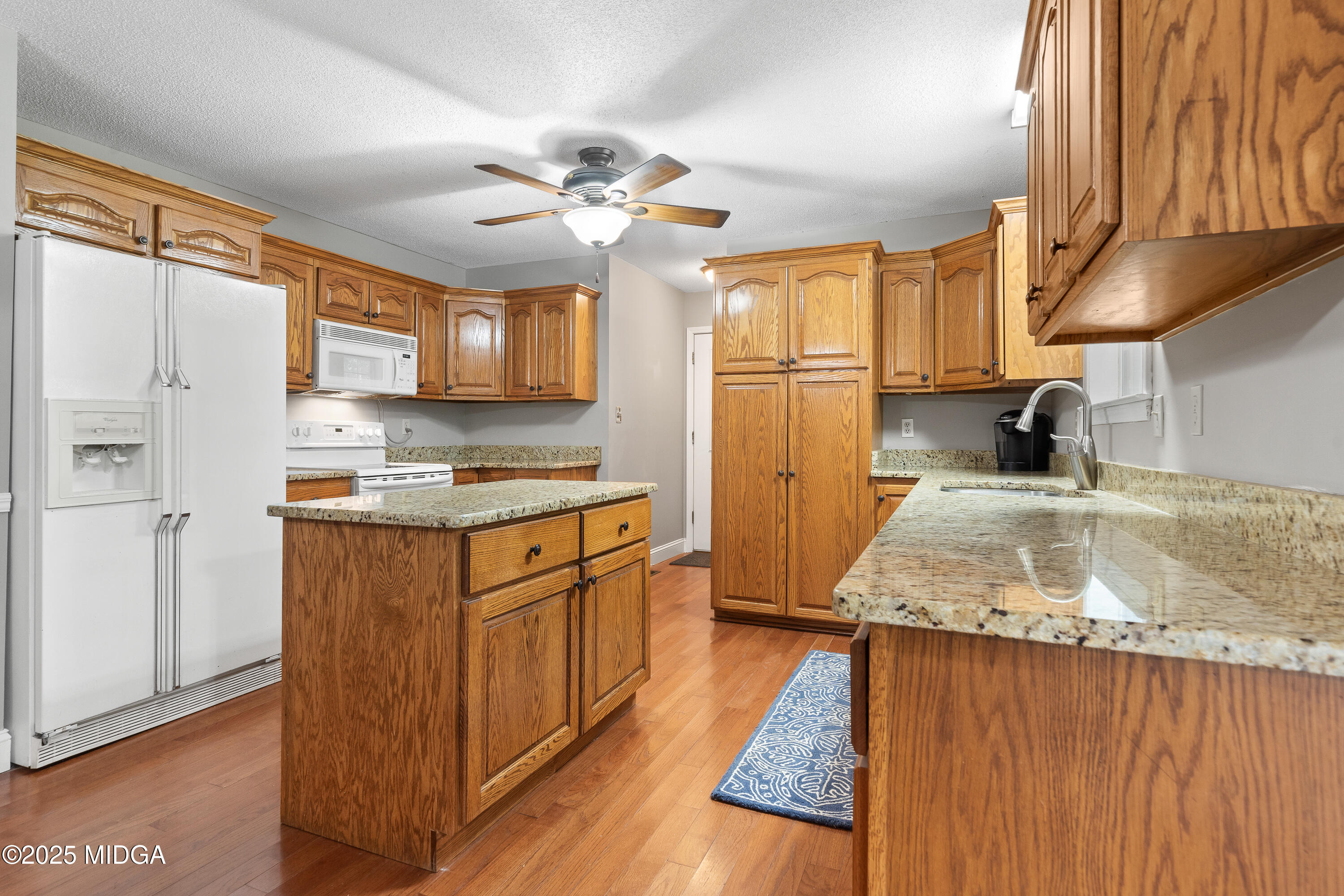 299 Colvin Road Forsyth, GA 31029 - Photo 12 of 51 a kitchen with stainless steel appliances granite countertop a sink stove and refrigerator