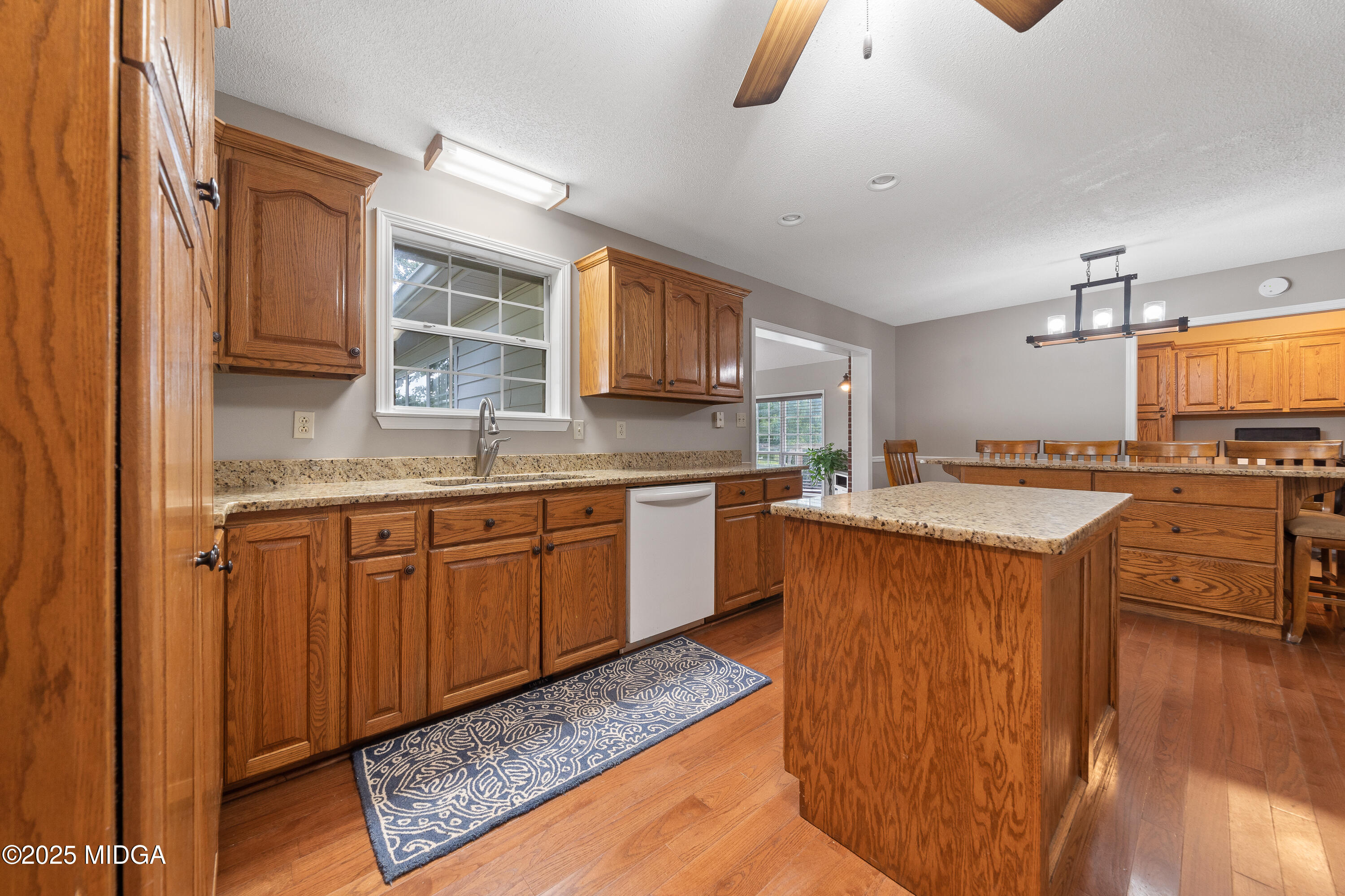 299 Colvin Road Forsyth, GA 31029 - Photo 14 of 51 a kitchen with wooden cabinets and a sink