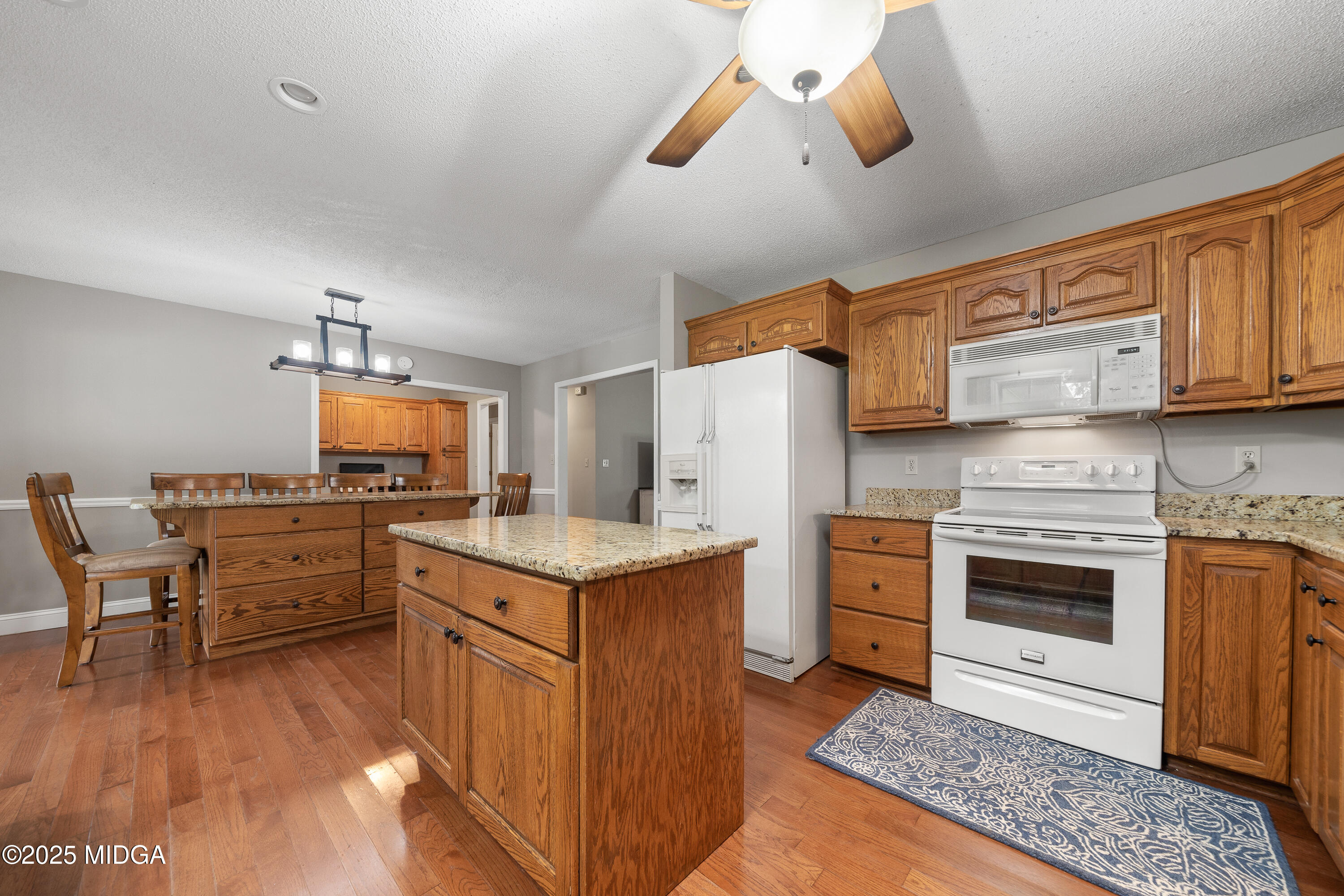299 Colvin Road Forsyth, GA 31029 - Photo 15 of 51 a kitchen with a stove a refrigerator and a stove top oven