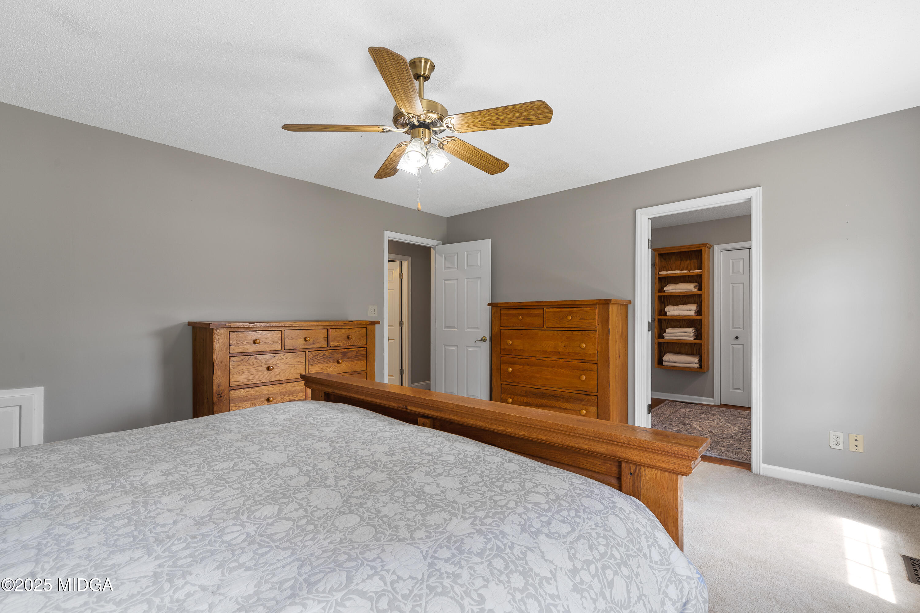 299 Colvin Road Forsyth, GA 31029 - Photo 19 of 51 a bedroom with a bed and a chandelier