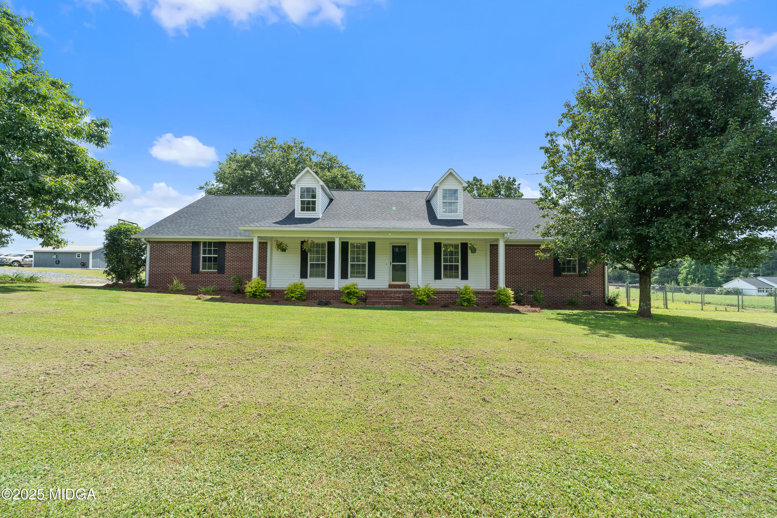 299 Colvin Road Forsyth, GA 31029 - Photo 2 of 51 a front view of a house with a garden