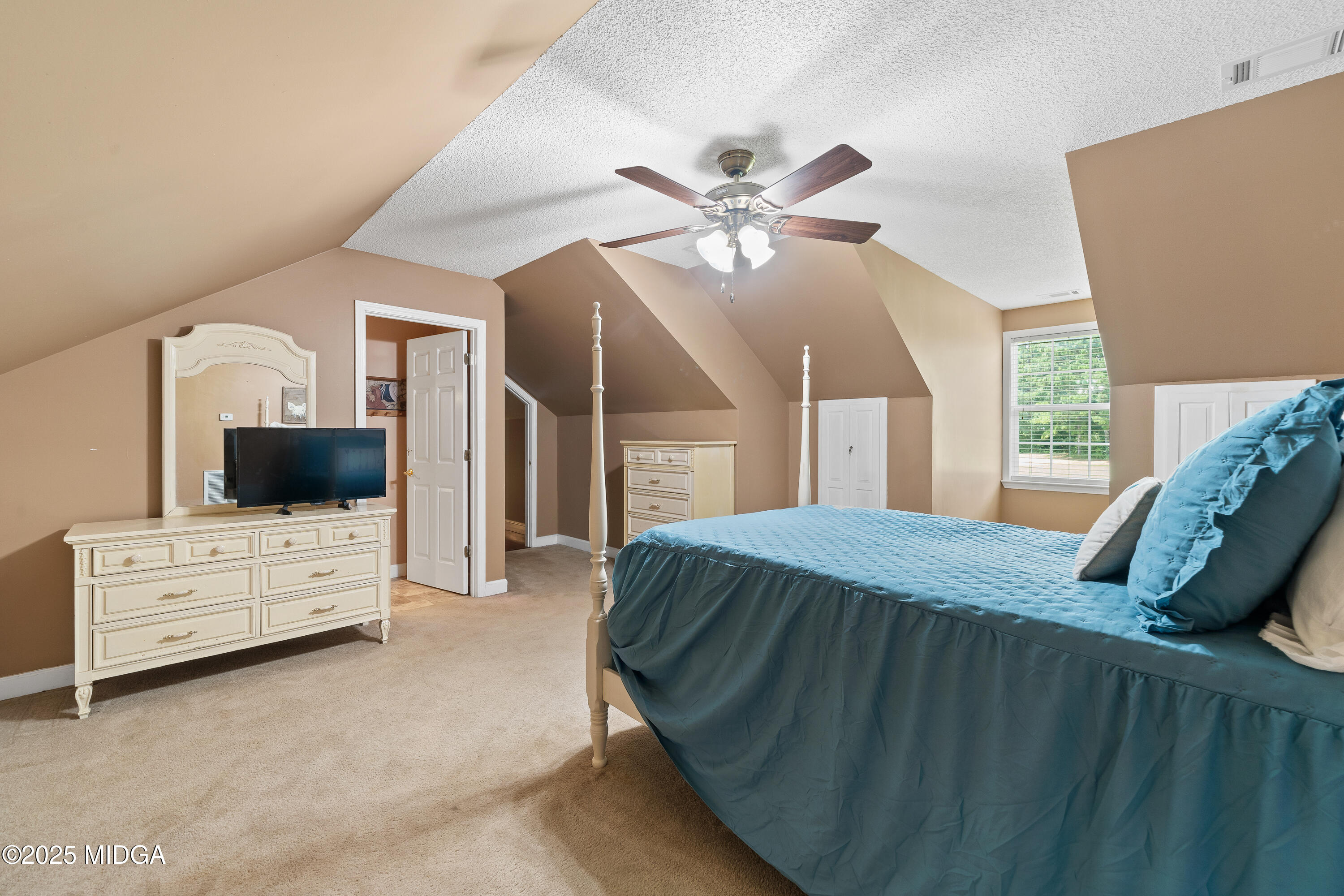 299 Colvin Road Forsyth, GA 31029 - Photo 29 of 51 a bedroom with a bed a flat screen tv and dresser