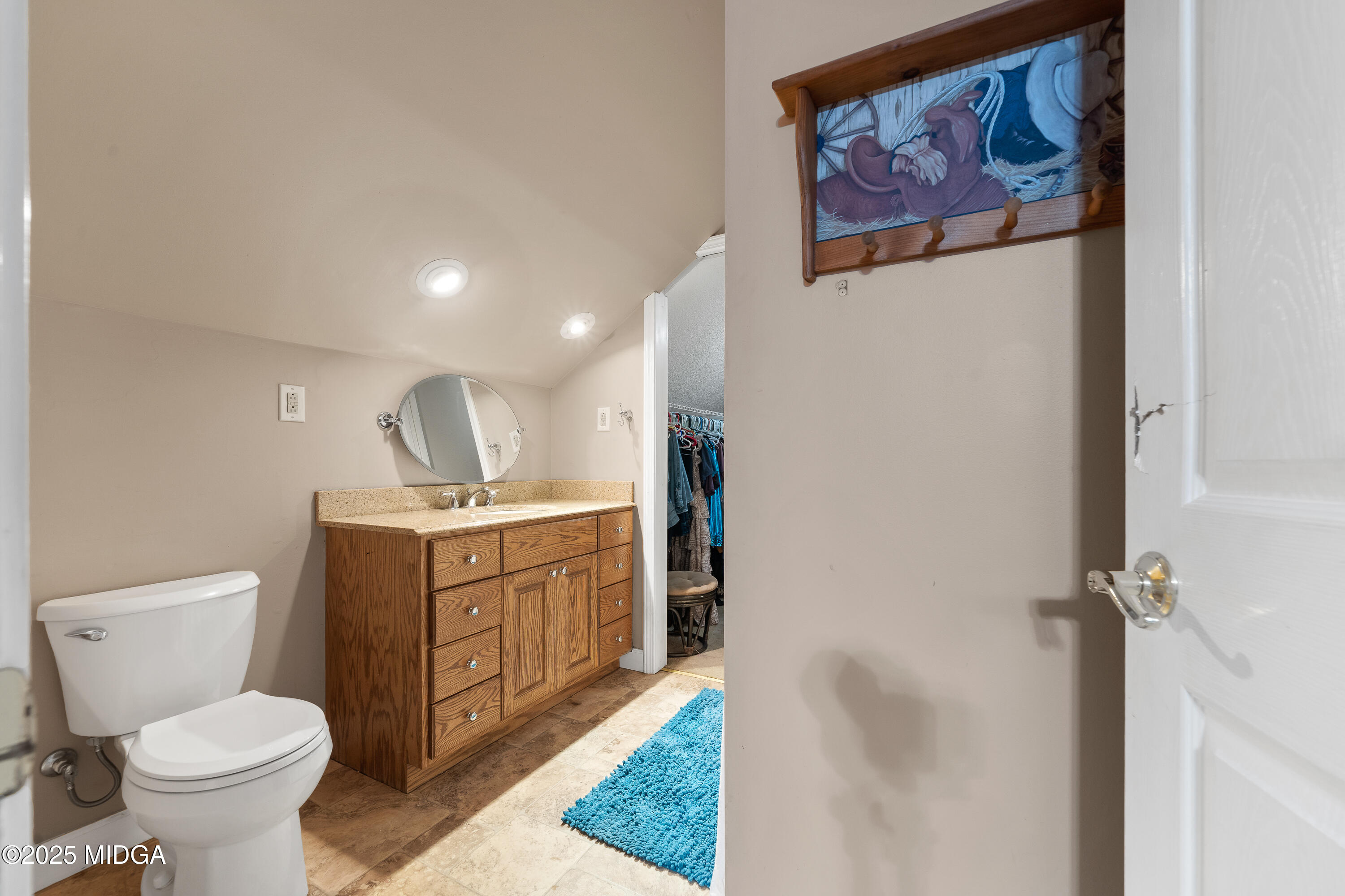 299 Colvin Road Forsyth, GA 31029 - Photo 30 of 51 a bathroom with a granite countertop sink mirror vanity and toilet