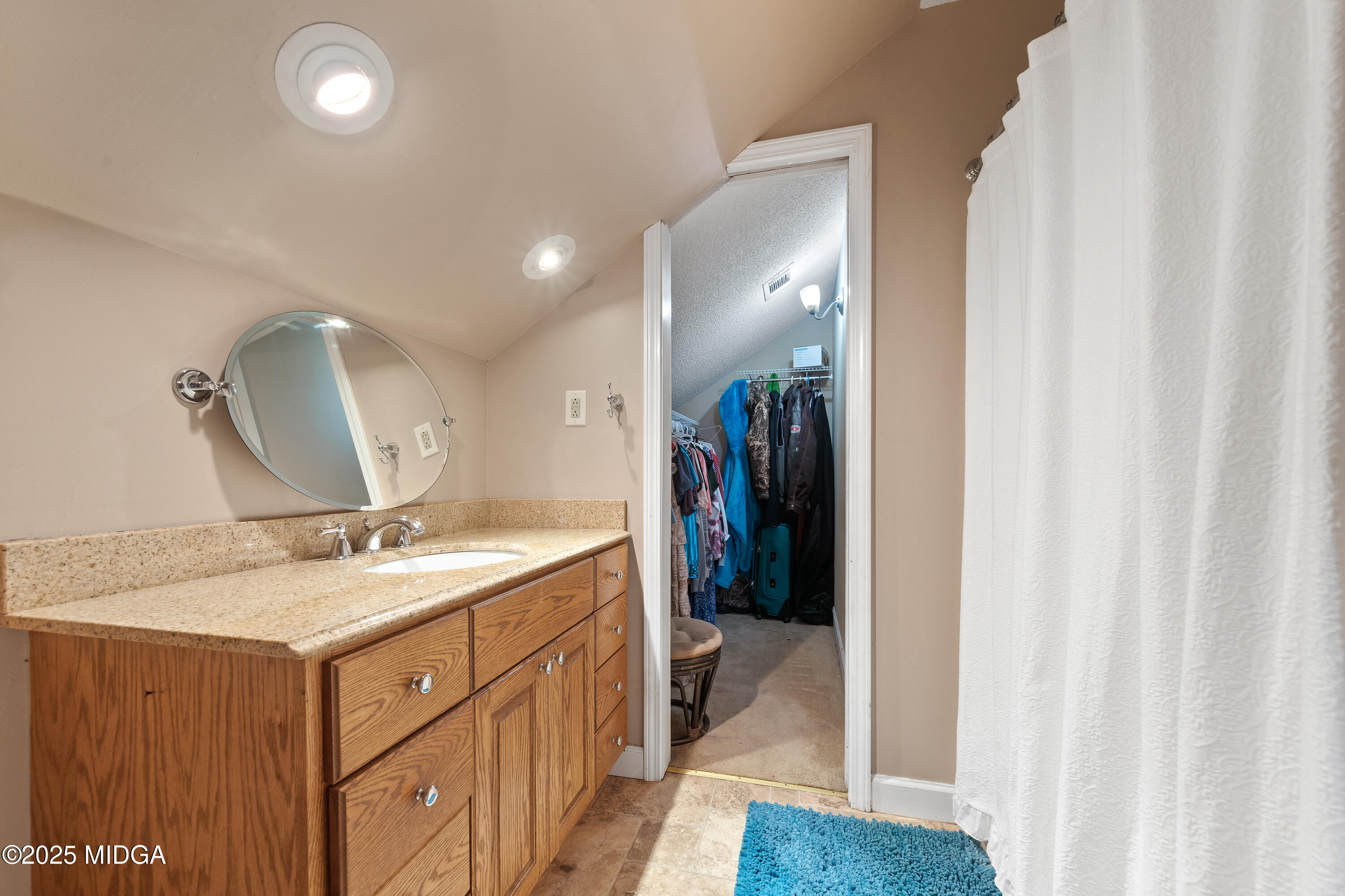 299 Colvin Road Forsyth, GA 31029 - Photo 31 of 51 a bathroom with a granite countertop sink a mirror and a shower