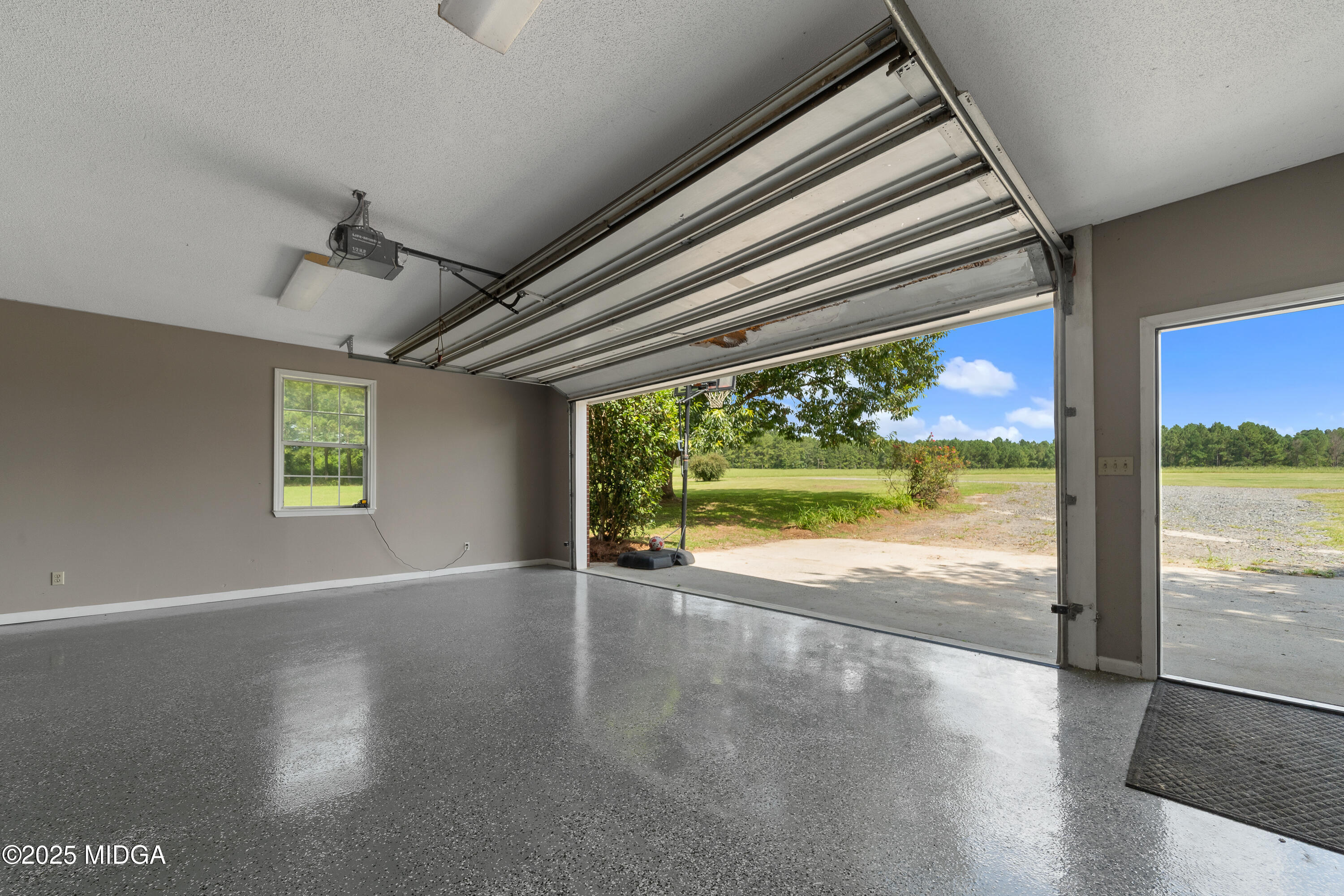 299 Colvin Road Forsyth, GA 31029 - Photo 49 of 51 a view of an empty room with wooden floor and a window