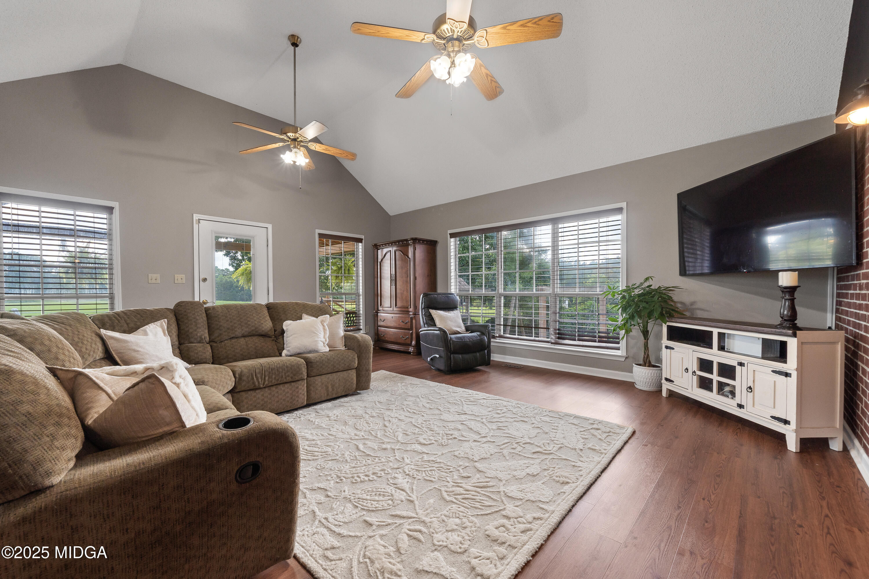299 Colvin Road Forsyth, GA 31029 - Photo 9 of 51 a living room with furniture and a flat screen tv