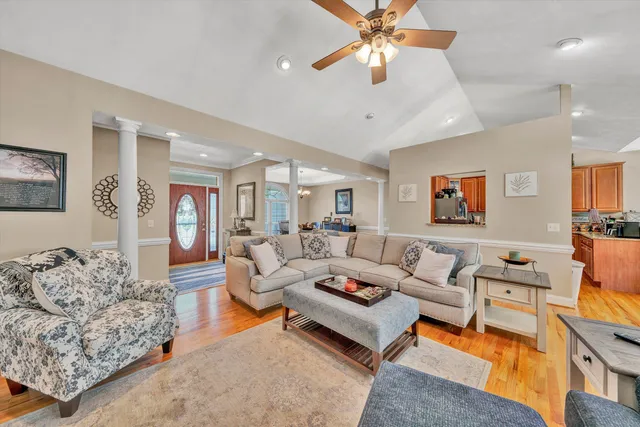 a living room with furniture a rug and a chandelier