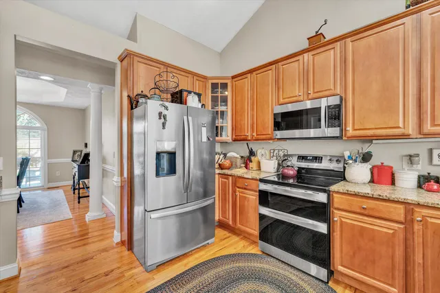 a kitchen with stainless steel appliances a stove a refrigerator and a microwave