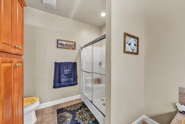 a bathroom with a toilet and a shower