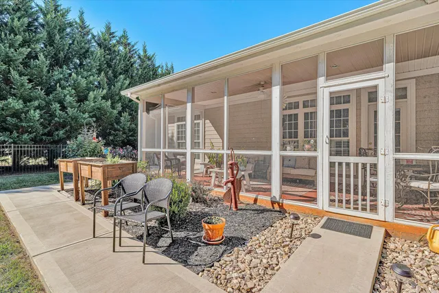 a backyard of a house with table and chairs