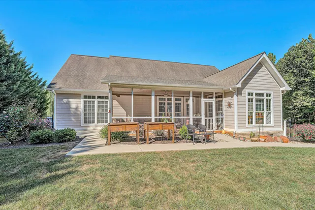 a front view of a house with sitting area and garden