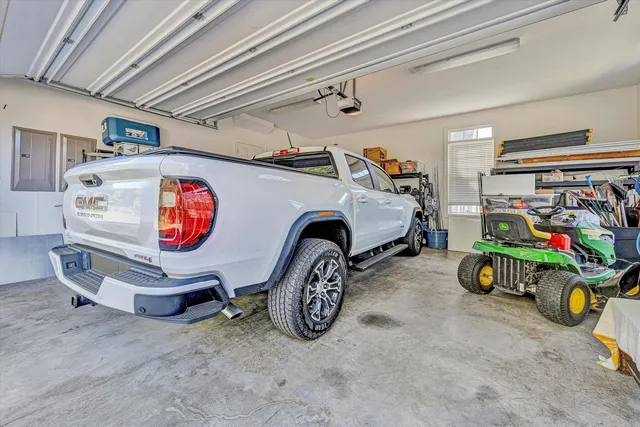 a utility room with dryer and cars