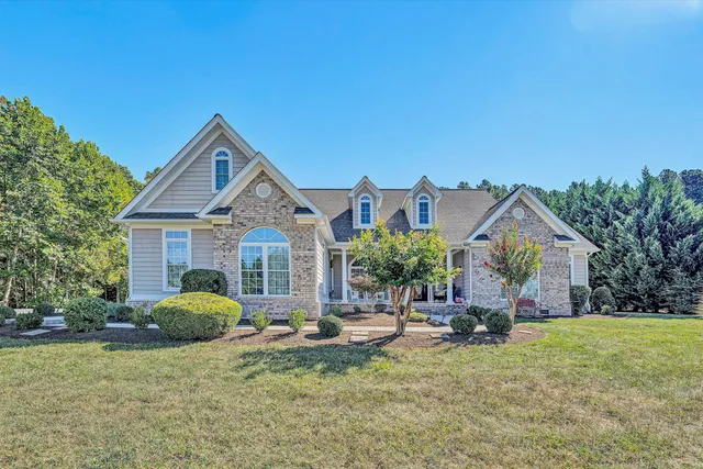 a view of a house with backyard and porch