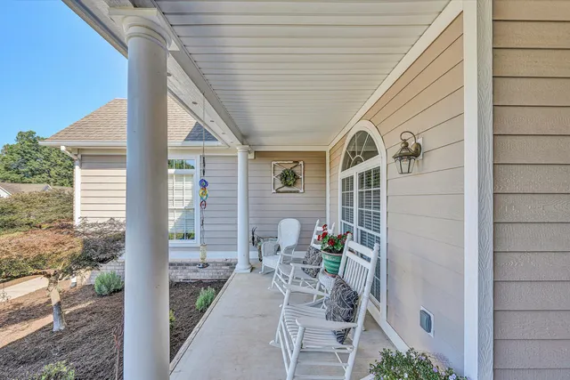 a front view of a house with outdoor seating