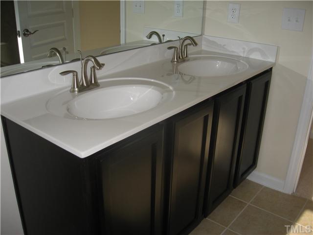 9125 Falkwood Road, Unit 163 Raleigh, NC 27617 - Photo 15 of 23 The dark espresso cabinets are throughout the whole home and create a nice contrast against the tiled shower and floor.