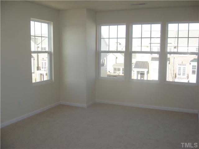 9125 Falkwood Road, Unit 163 Raleigh, NC 27617 - Photo 16 of 23 The secondary bedroom has extra windows that allows natural light to enter.