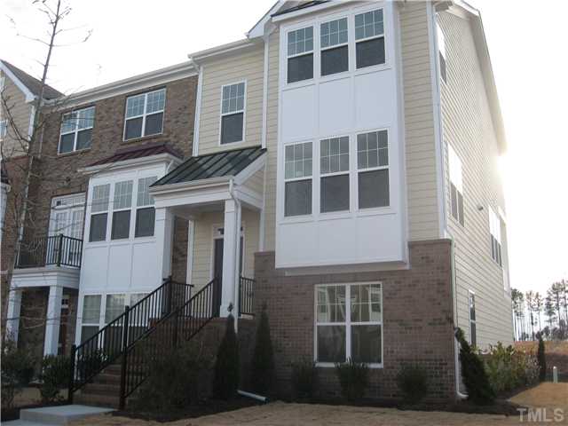 9125 Falkwood Road, Unit 163 Raleigh, NC 27617 - Photo 3 of 23 Maintenance free living with this home. Brick and hardi plank exterior with twin bay window in the family and secondary bedroom. Professional landscaping surrounds the home.