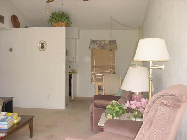 625 South Power Road, Unit 367 Mesa, AZ 85206 - Photo 3 of 4 a bed room with a bed and a lamp