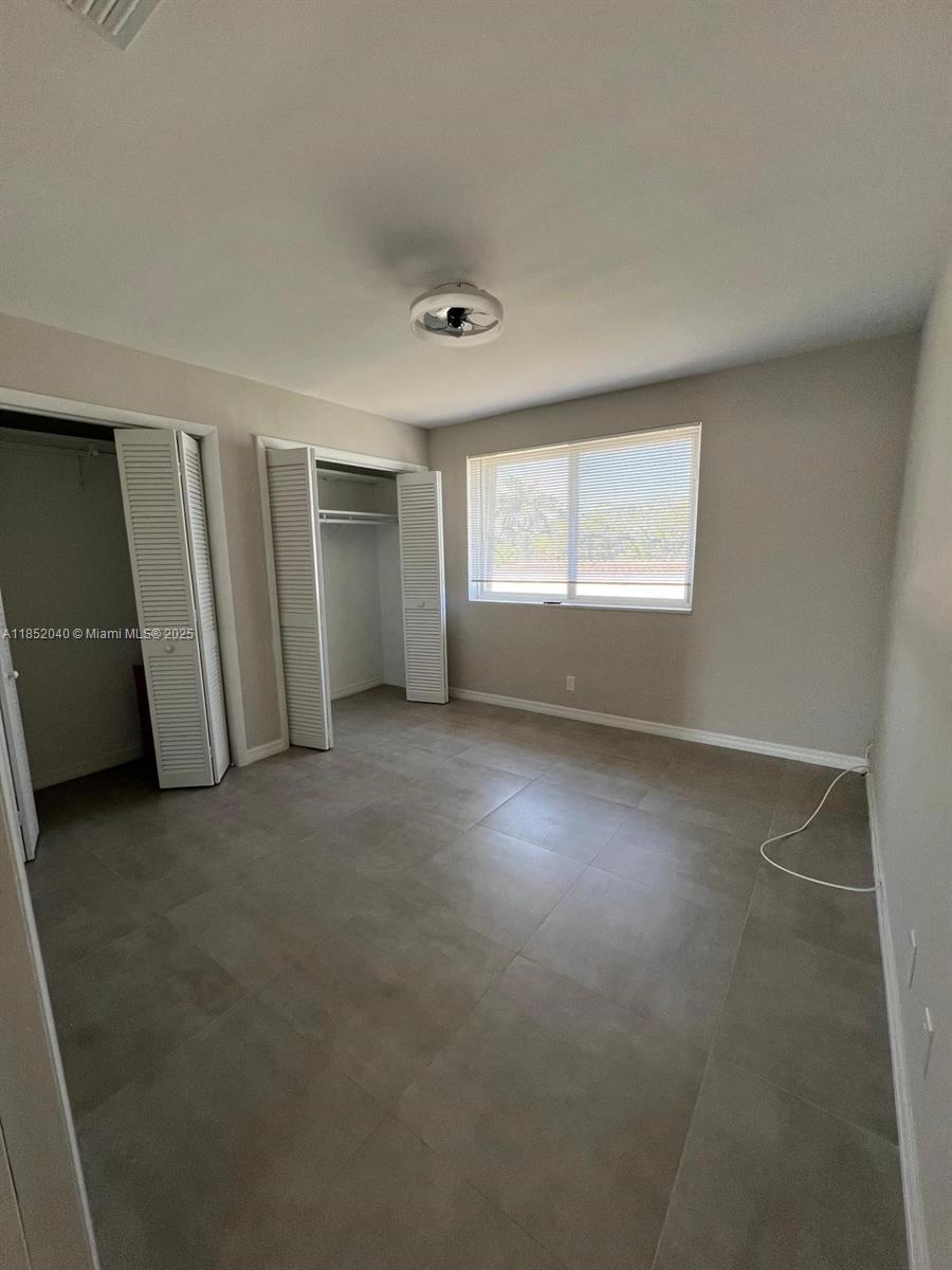 2175 Northeast 56th Street, Unit 211 Fort Lauderdale, FL 33308 - Photo 14 of 15 an empty room with windows