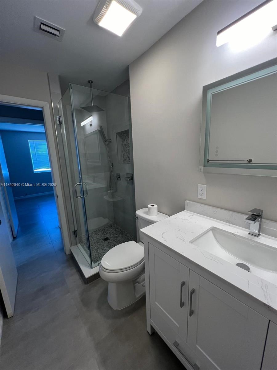 2175 Northeast 56th Street, Unit 211 Fort Lauderdale, FL 33308 - Photo 10 of 15 a bathroom with a sink a toilet and shower