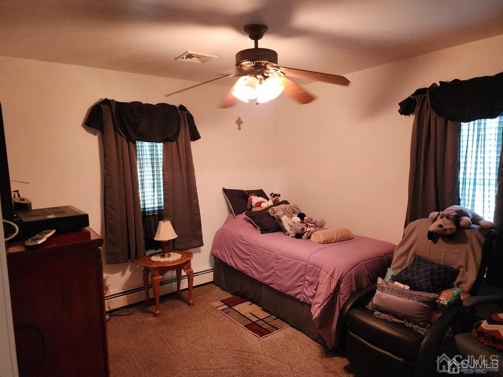 184 Raritan Street Keyport, NJ 07735 - Photo 11 of 24 a bedroom with a bed and a chandelier