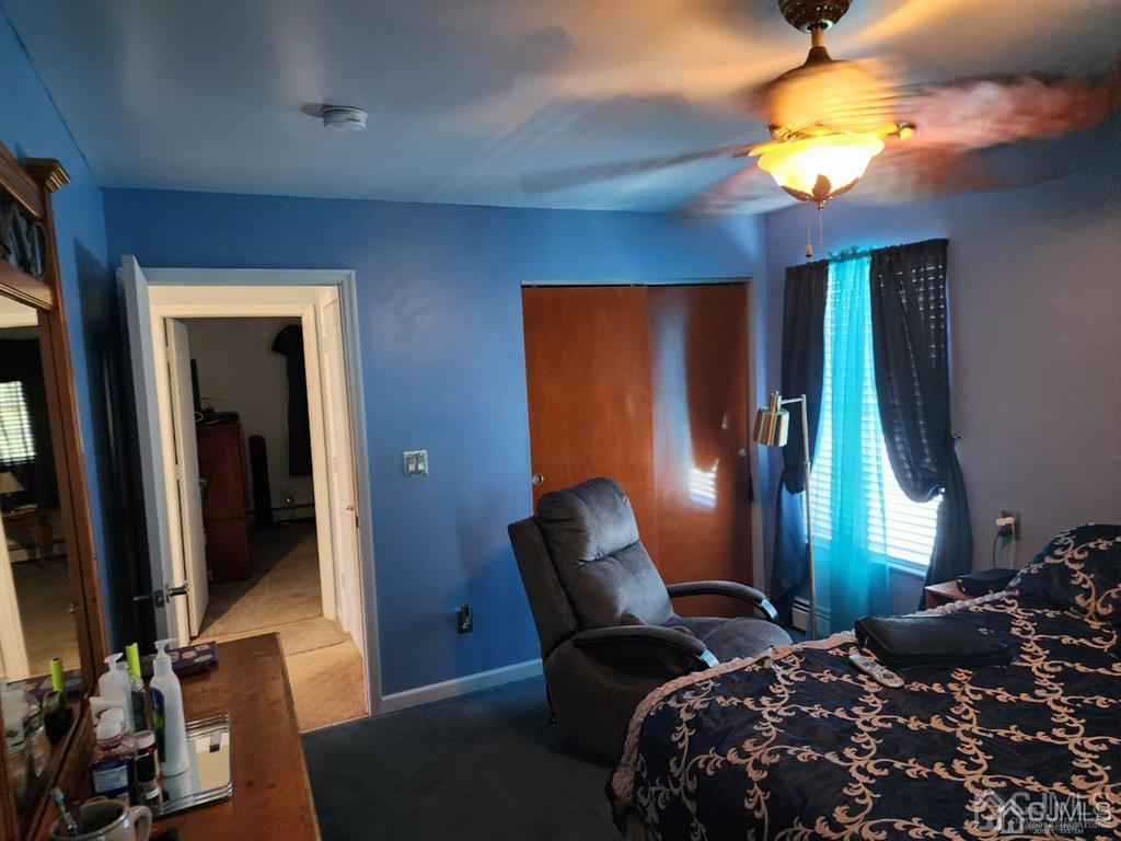 184 Raritan Street Keyport, NJ 07735 - Photo 14 of 24 a bedroom with bed and a chandelier