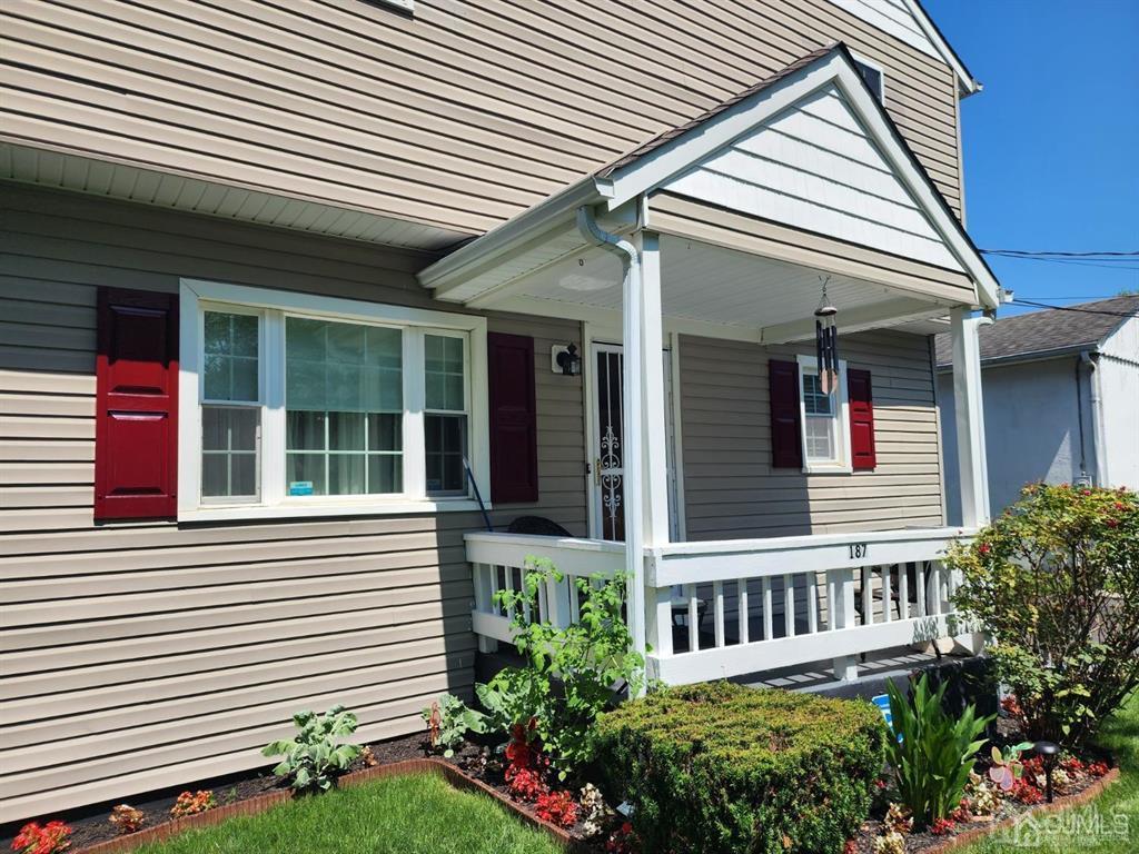 184 Raritan Street Keyport, NJ 07735 - Photo 20 of 24 a view of a house with large windows and flower plants