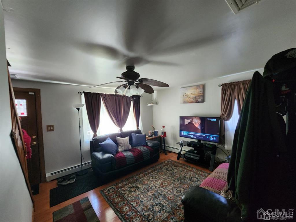 184 Raritan Street Keyport, NJ 07735 - Photo 3 of 24 a living room with furniture a flat screen tv and a window