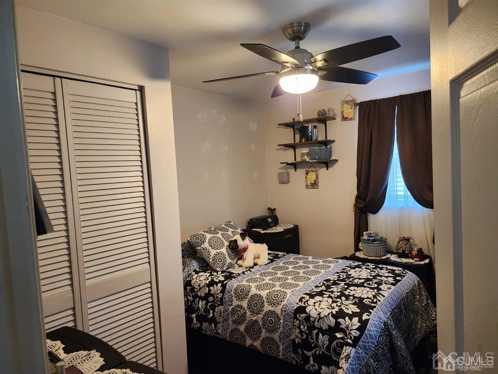 184 Raritan Street Keyport, NJ 07735 - Photo 6 of 24 a bedroom with a bed and a chandelier